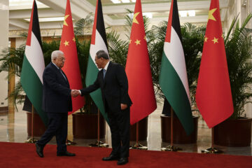 Chinese Premier Li Qiang, right, receives Palestinian President Mahmoud Abbas