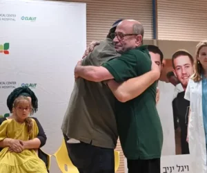 The Yaniv boys' father embraces one of the recipients.