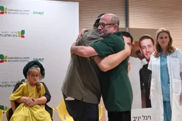 The Yaniv boys' father embraces one of the recipients.