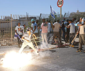 A stun grenade thrown by Israeli police explodes next to Eritrean protesters during a protest against an event organized by the Eritrea Embassy, in Tel Aviv, Israel, September 2, 2023. (AP Photo/Ohad Zwigenberg)