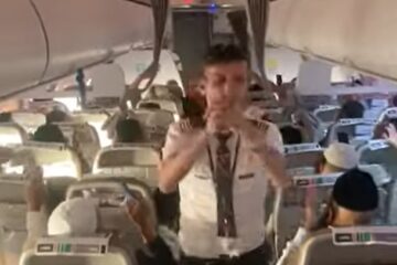 Co-pilot leads Uman bound passengers in song.