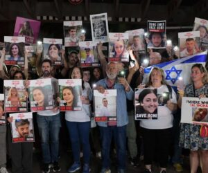 hostages families holding signs of loved ones