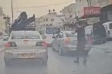 A Palestinian terrorist shoots at an Israeli ca