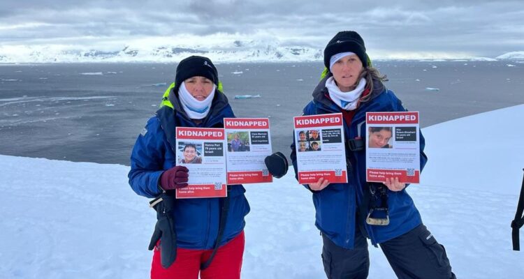 Researchers from Haifa University hold hostage posters in Antartica