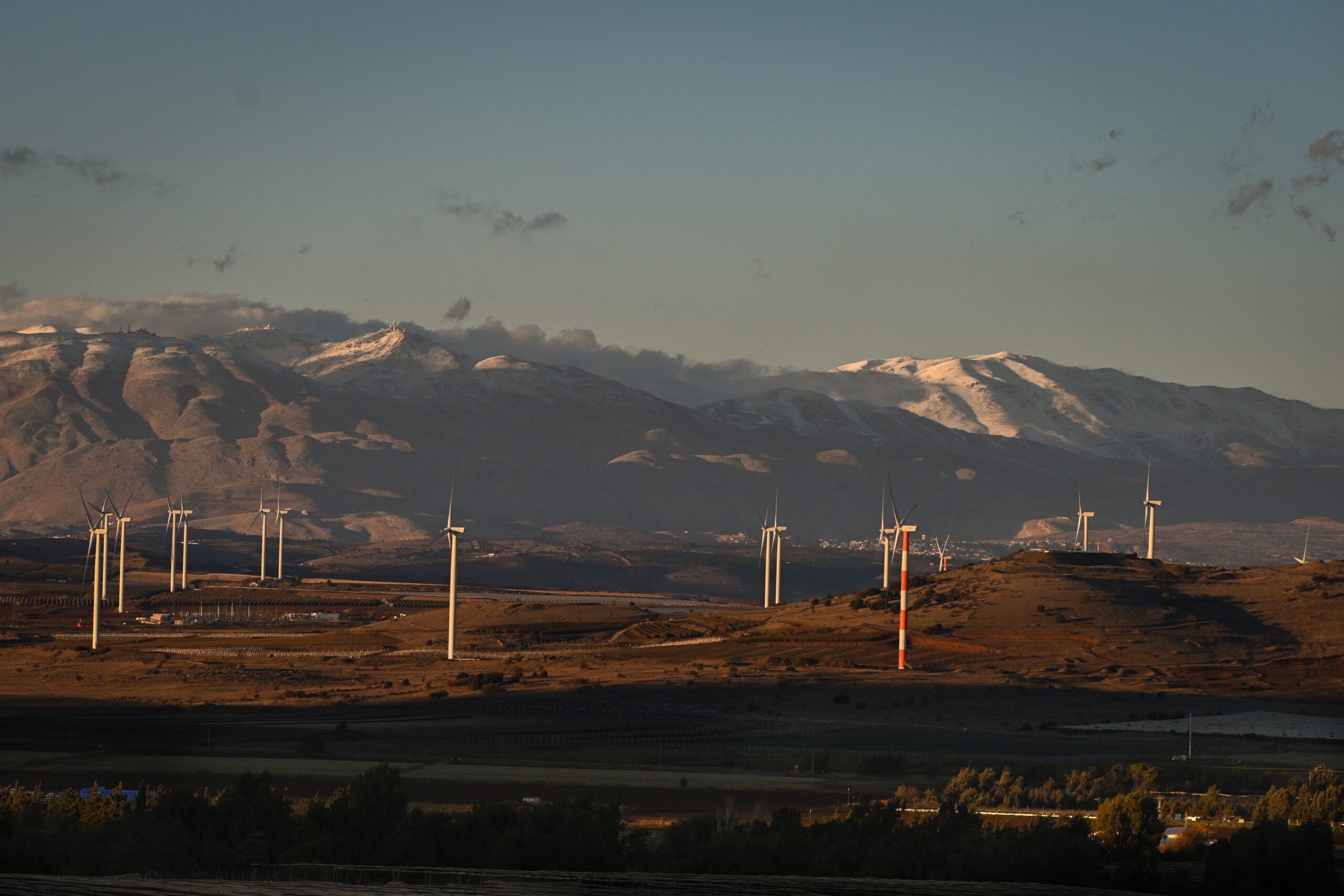 A station of wind turbines with snowy Mount Hermon in the background in the Golan Heights, November 26, 2024. Photo by Michael Giladi/ Flash90