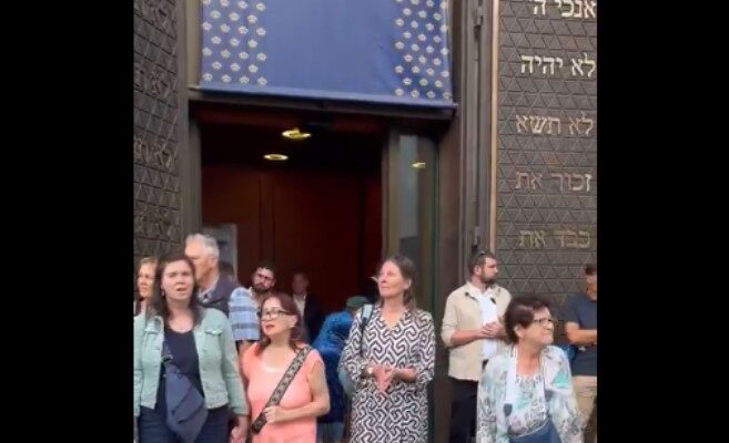 Munich residents form human chain to protect synagogue from anti-Israel protest marked by antisemitic chants