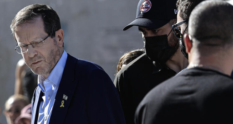 Herzog visits graves of soldiers slain in Hamas war