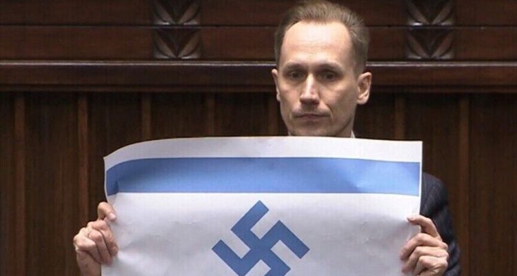 Polish MP ripped for holding up swastika flag on Holocaust Remembrance Day